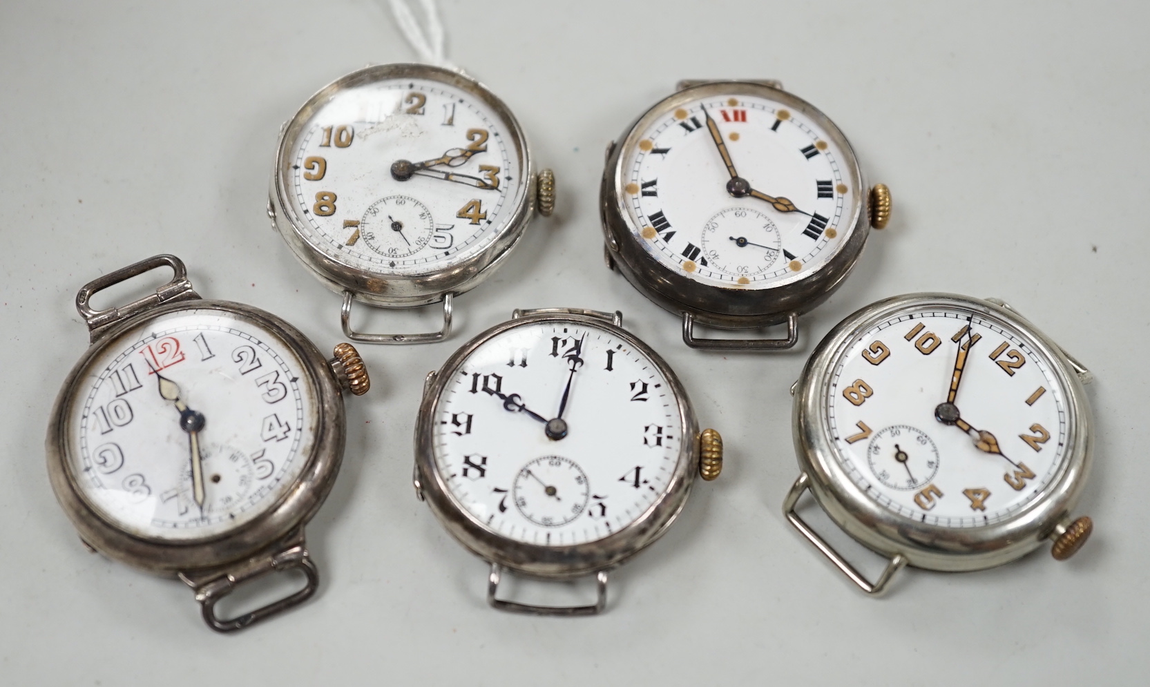 Five assorted early to mid 20th century manual wind wrist watches, including four silver.